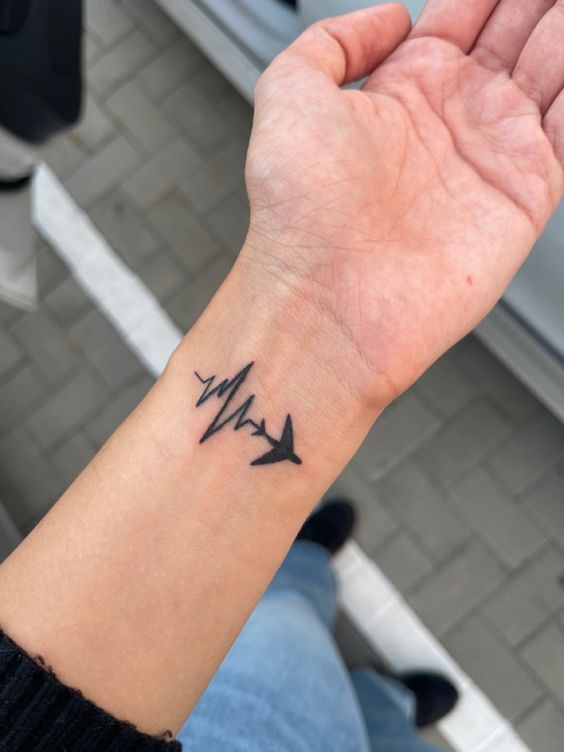 Airplane with Heartbeat Tattoo on Wrist